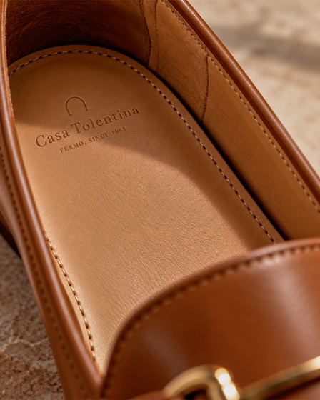 Casa Tolentina loafer showing the branded leather insole, showroom photography